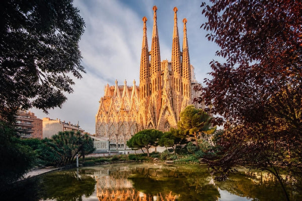 The Sagrada Familia rising above Barcelona rooftops at golden hour in Spain
