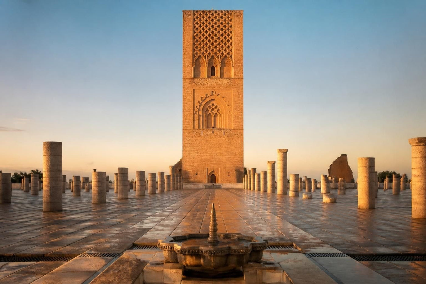 The Koutoubia Mosque minaret rising above palm trees in Marrakech, Morocco, at golden hour